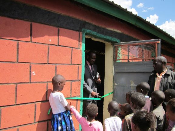 Bishop orphanage dedication cutting ribbon